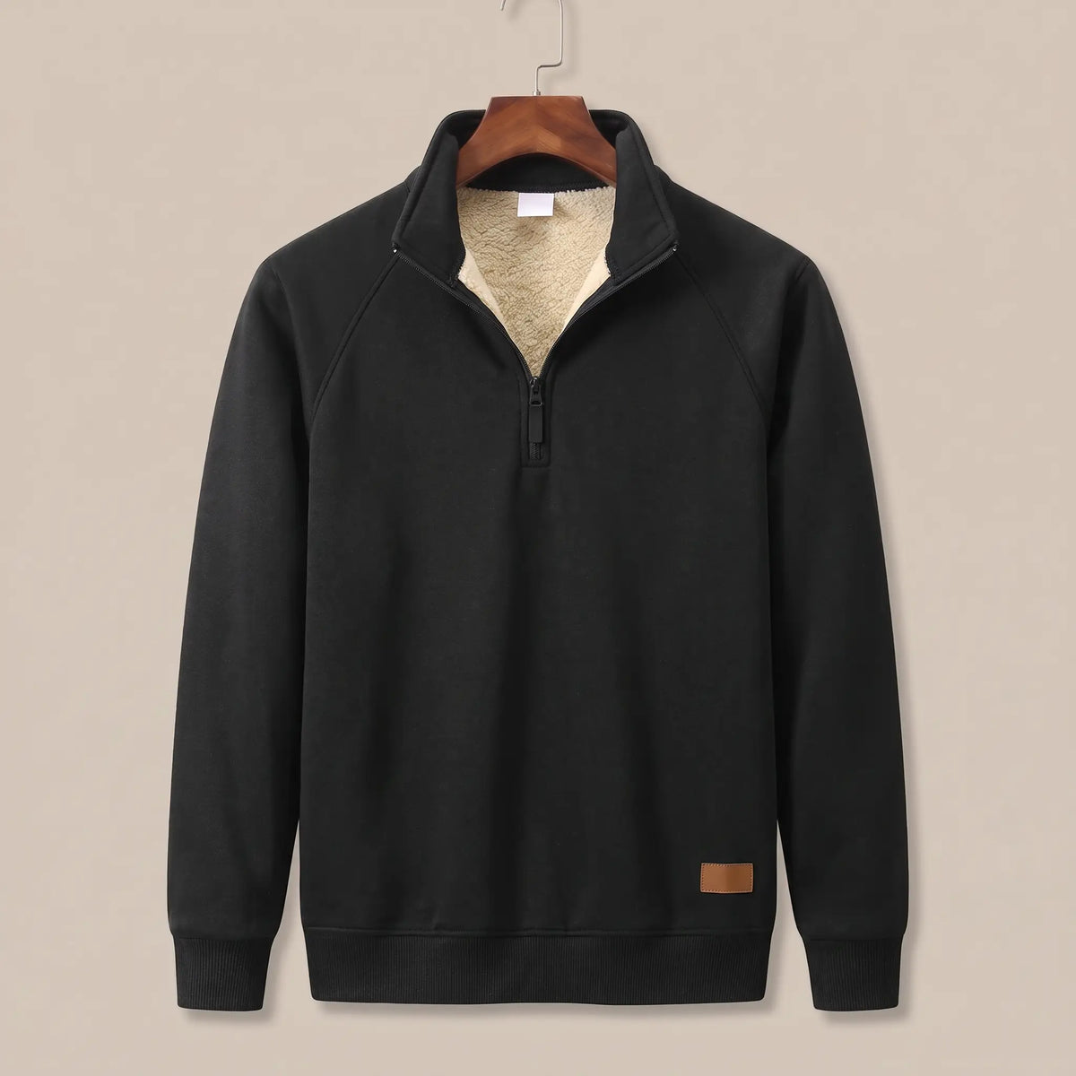 Heather knit sweater in black with sherpa-lined quarter-zip collar, on a wooden hanger
