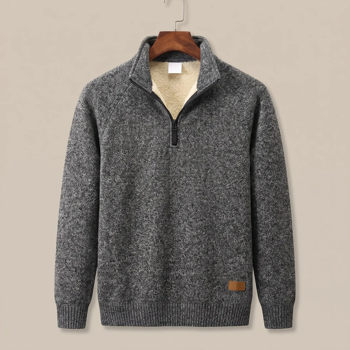 Heather knit sweater in dark grey with sherpa-lined quarter-zip collar, on a wooden hanger