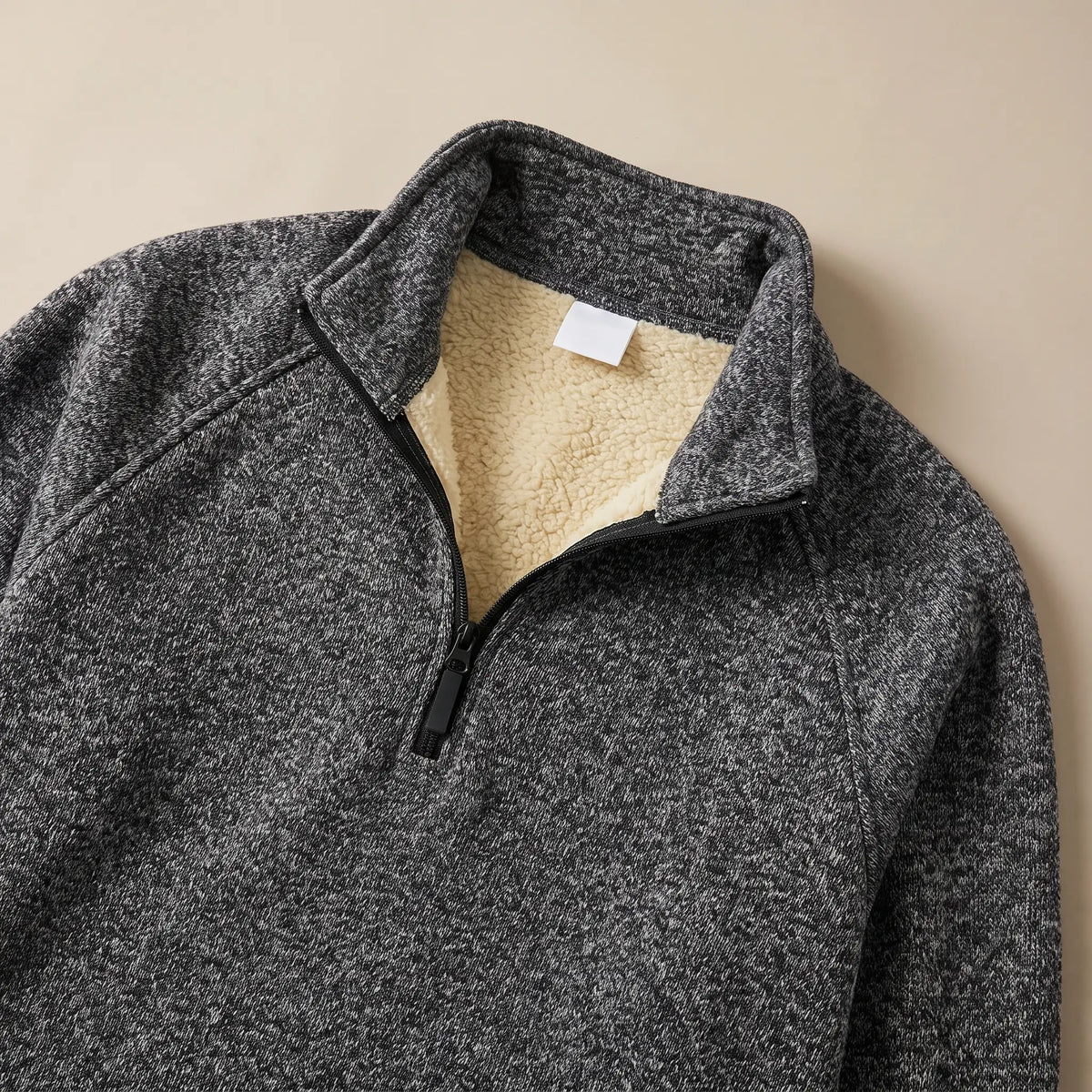 Close-up of the dark grey heather knit sweater collar showing the soft sherpa lining and zip