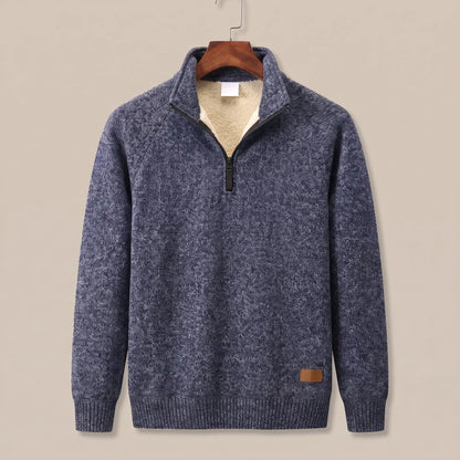 Heather knit sweater in navy blue with sherpa-lined quarter-zip collar, on a wooden hanger
