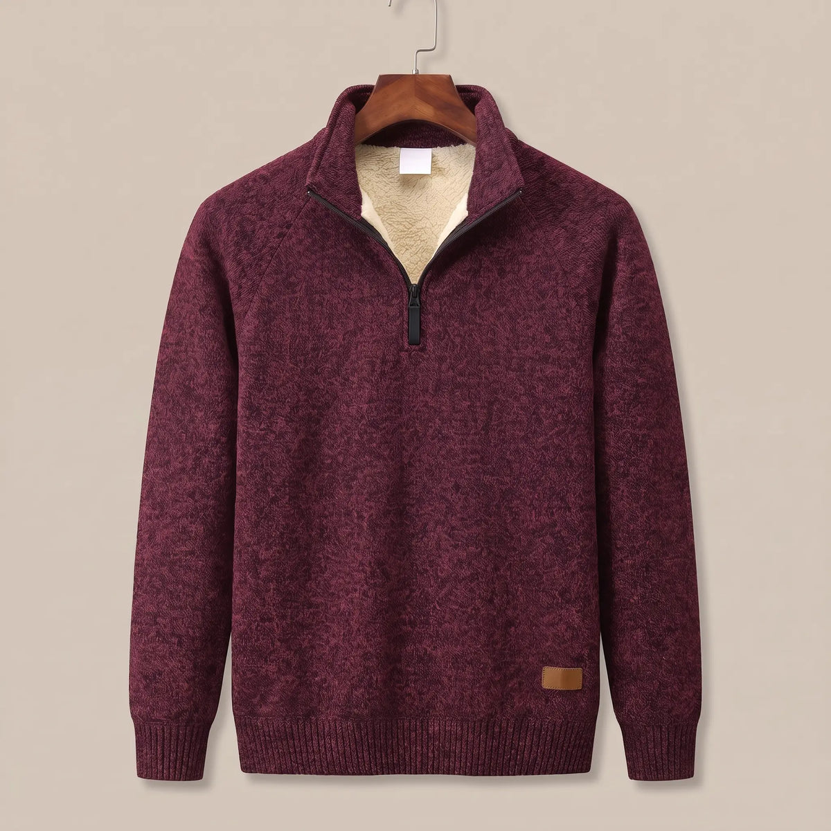 Heather knit sweater in deep red with sherpa-lined quarter-zip collar, on a wooden hanger