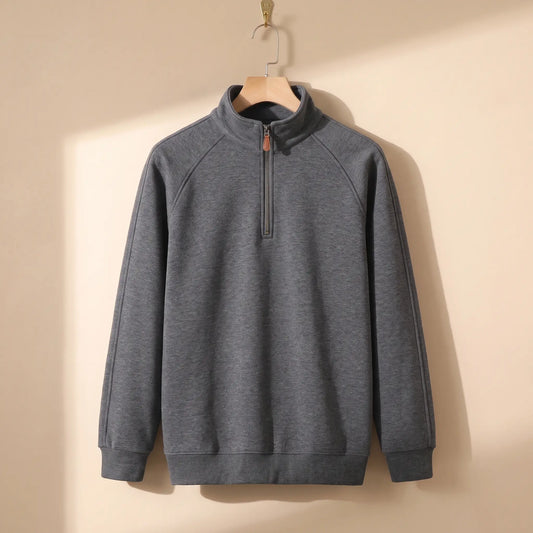 Heather quarter-zip top in dark grey on a wooden hanger