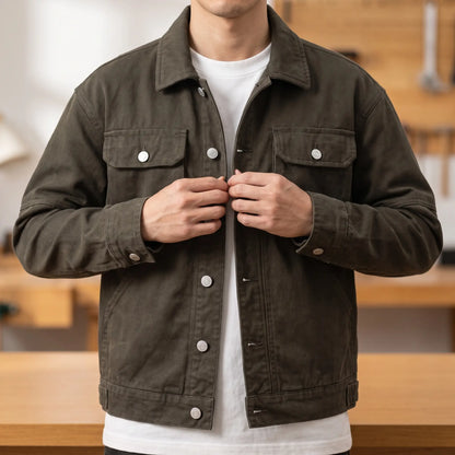Man wearing the army green heavy canvas trucker jacket and buttoning the front