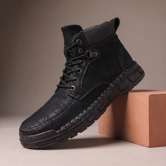 Black heavy lug moc toe boot on a terracotta display block