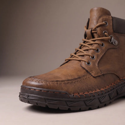 Close up of the moc toe stitching, lacing and lug sole on the brown heavy lug boot