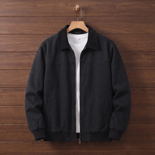 Men's black washed canvas work jacket with black corduroy collar and zip front on a wooden hanger