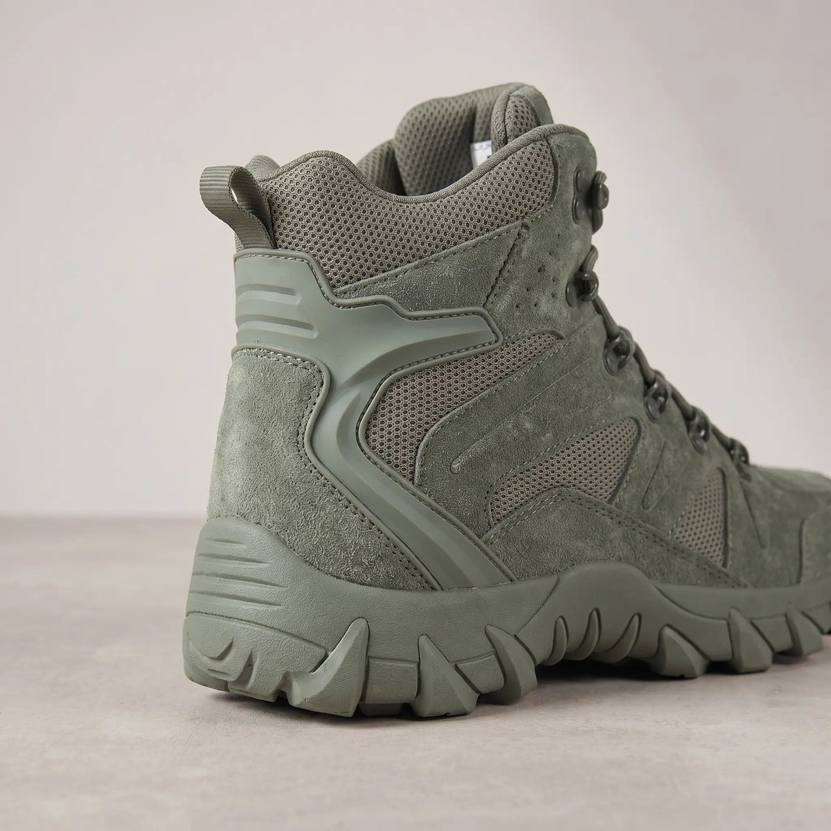 Heel, pull loop and lug sole of green high-top tactical boots for men