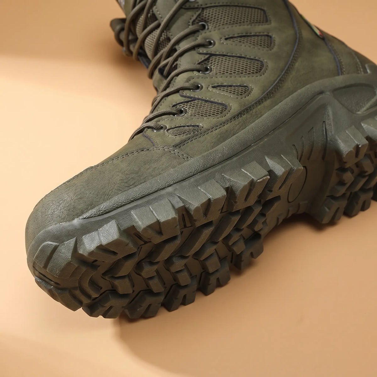 Close-up of the green high lace boot toe and deep lug sole