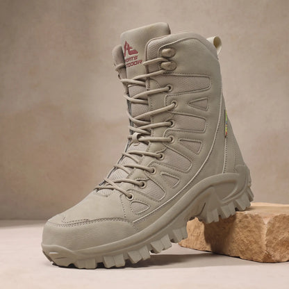 Men's khaki high lace-up leather boot with vented side panels on a sandstone block