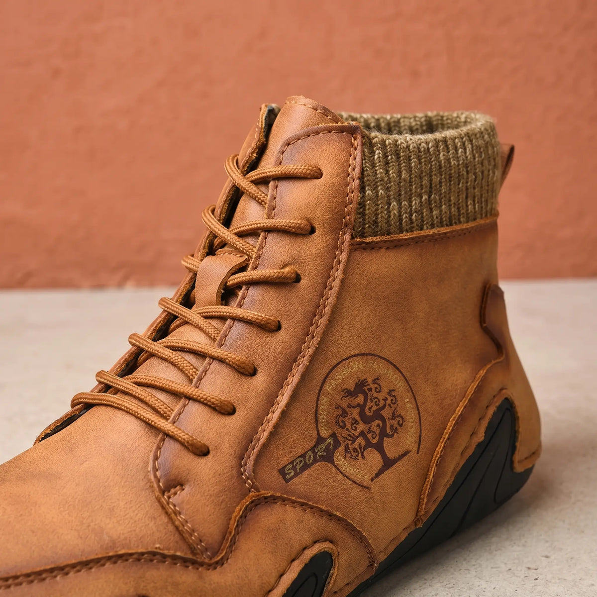 Close-up of the brown knit collar boot laces and side emblem