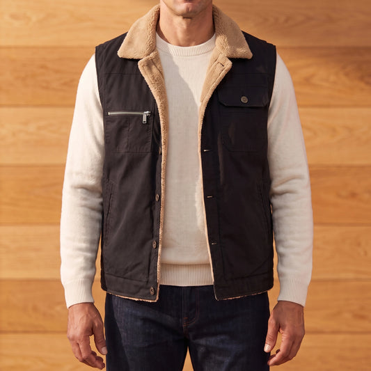 Men's black lapel collar vest with camel fleece collar and lining, worn open over an off-white sweater