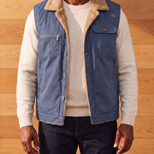 Men's blue lapel collar vest with tan sherpa collar, worn over an off-white sweater