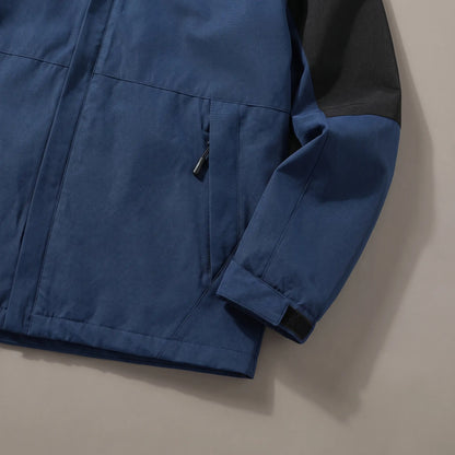 Close up of the zip hand pocket and adjustable cuff tab on the navy blue layered hooded jacket
