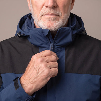 Man zipping up the navy blue layered hooded jacket to the collar