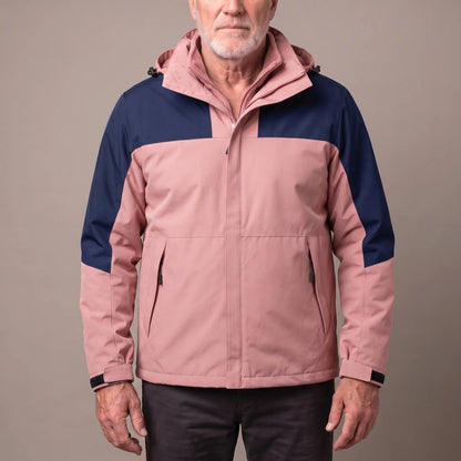Men's pink hooded shell jacket with navy blue shoulder panels and a zip-in fleece, worn zipped