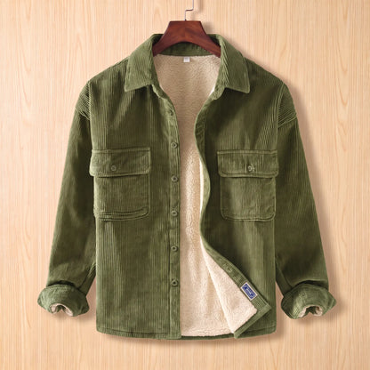 Layering Shirt Jacket in green, a fleece lined corduroy overshirt with two buttoned chest pockets on a wooden hanger