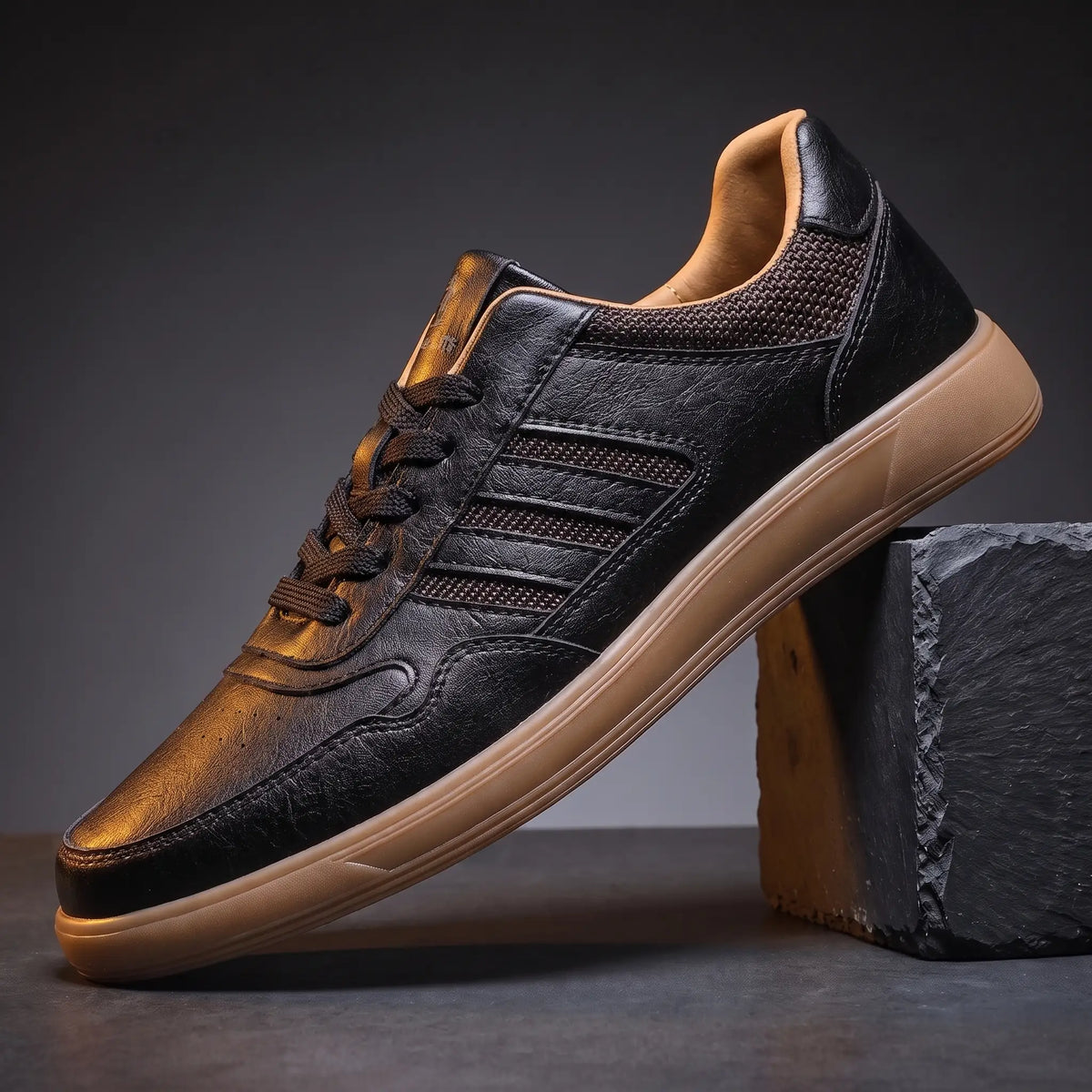 Black leather court sneakers with four raised side bars and flat gum sole