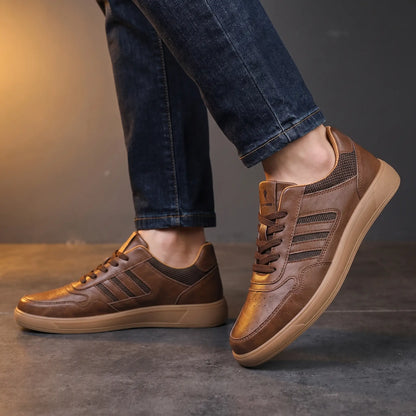 Man wearing brown leather court sneakers with dark indigo denim
