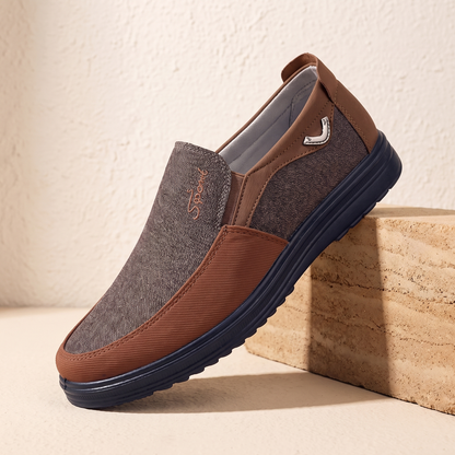 Brown canvas and leather slip-on loafer with navy cup sole