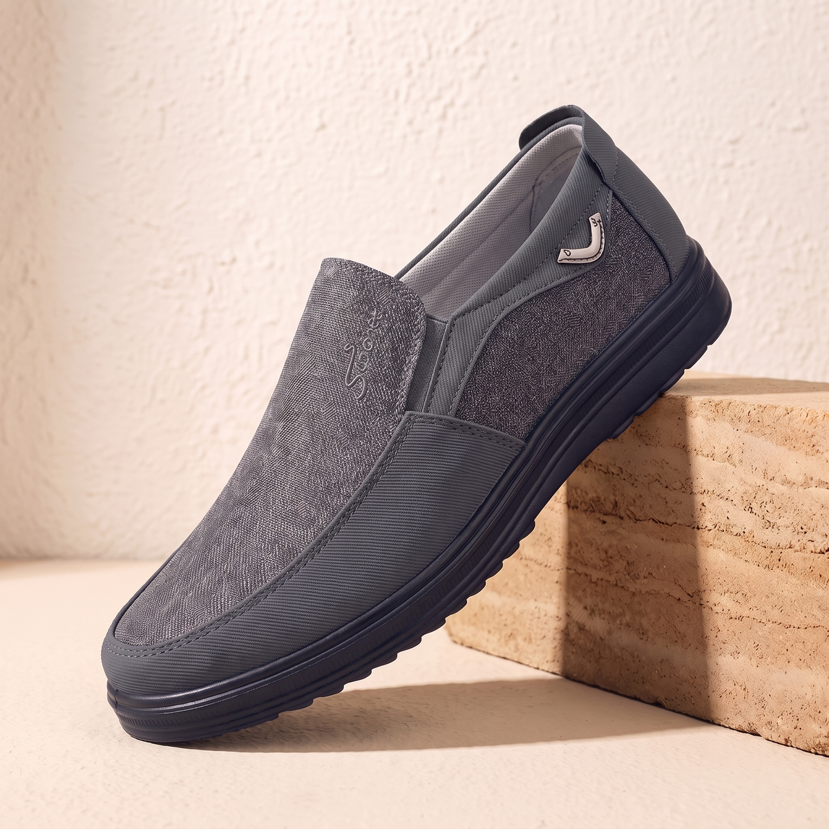 Grey canvas and leather slip-on loafer with black cup sole