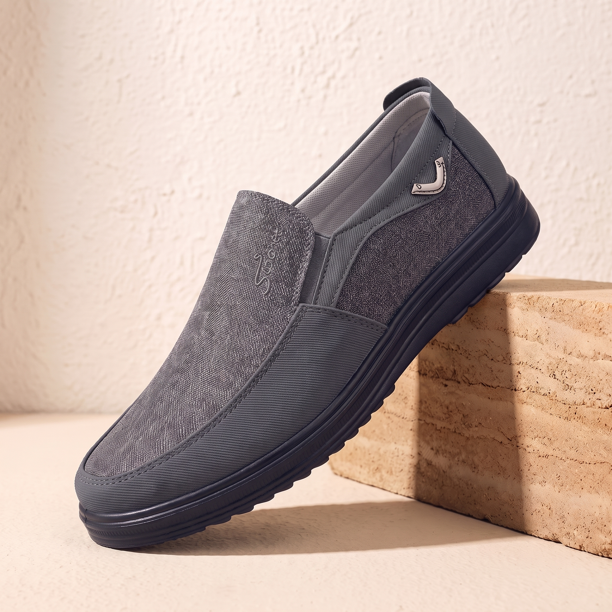 Grey canvas and leather slip-on loafer with black cup sole