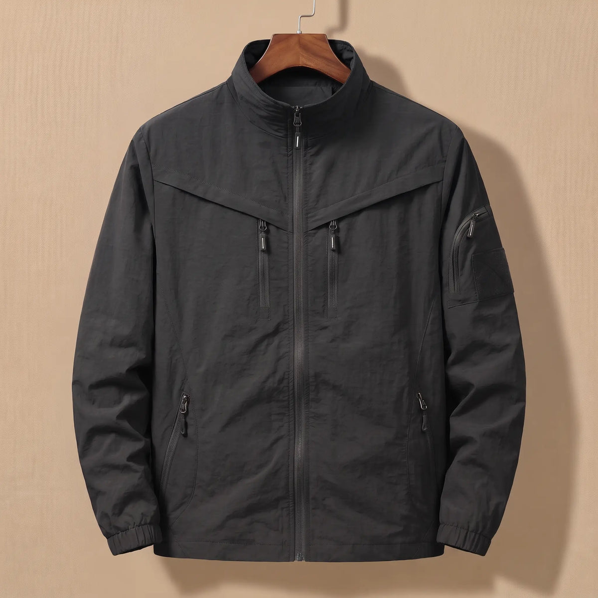 Men's black lightweight utility jacket with five zip pockets on a wooden hanger