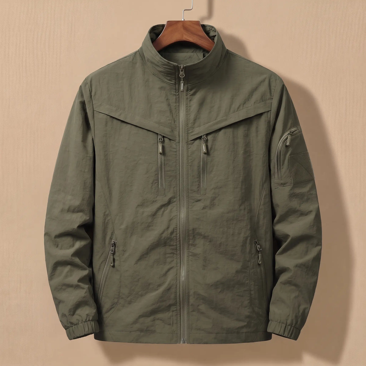 Men's army green lightweight utility jacket with five zip pockets on a wooden hanger