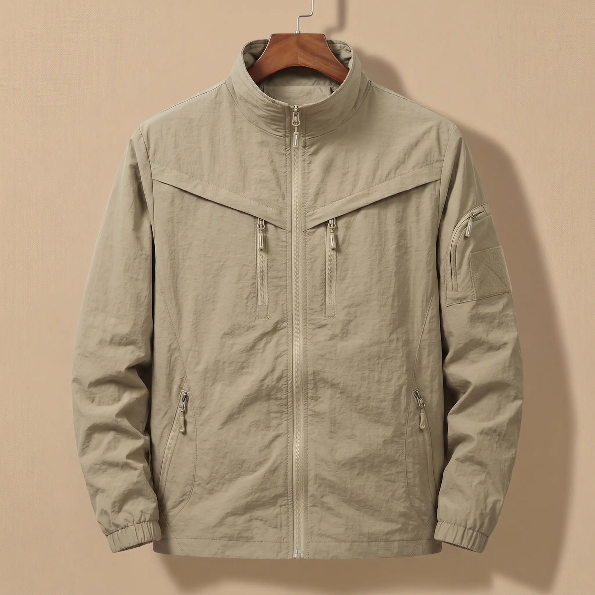 Men's khaki lightweight utility jacket with five zip pockets on a wooden hanger
