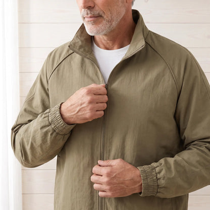 Man zipping up khaki work jacket