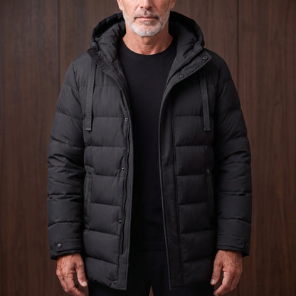Men's black long hooded puffer coat with quilted padding, worn open over a black tee