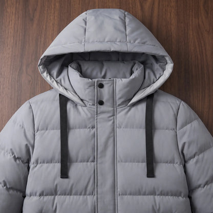 Close up of the padded hood, collar and wide drawcords on the grey long puffer coat