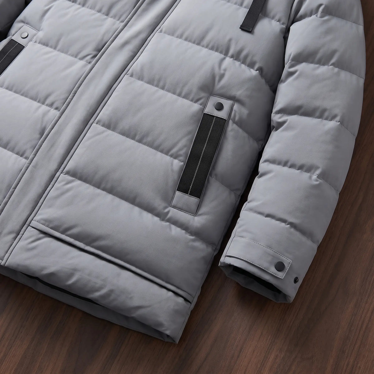 Close up of the side pocket and snap cuff on the grey long puffer coat