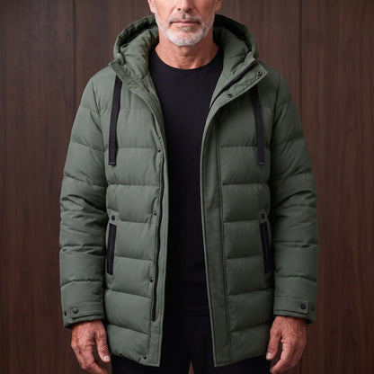 Men's green long hooded puffer coat with quilted padding, worn open over a black tee