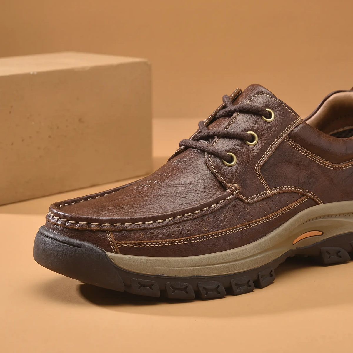 Lug Sole Moc Shoes in Brown, moc toe and brass eyelets close-up