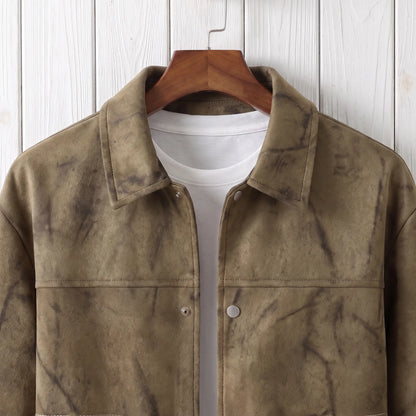 Close up of the collar, yoke seam and snap button on the khaki marbled dye jacket