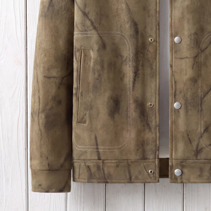 Close up of the waist patch pocket, hem and cuff on the khaki marbled dye jacket