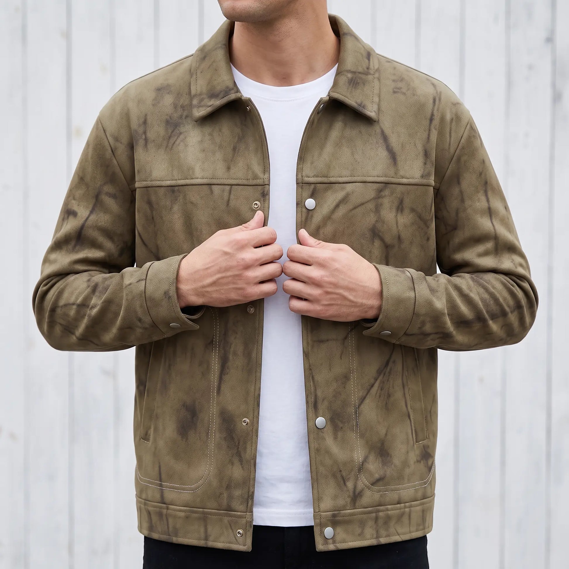 Man wearing the khaki marbled dye trucker jacket and snapping the front closed