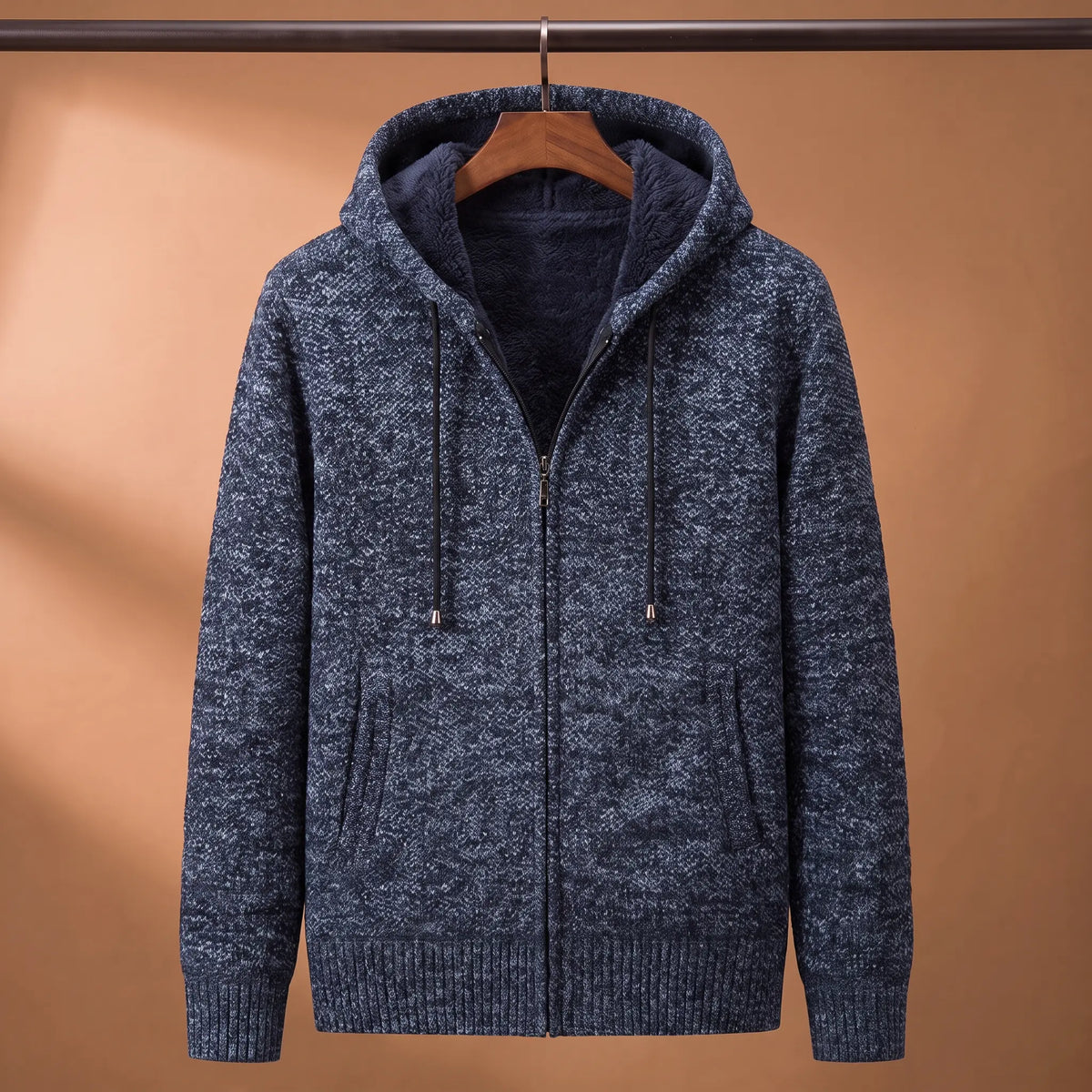 Marled knit hoodie in blue with fleece-lined hood on a wooden hanger