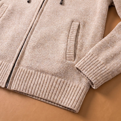 Close-up of the beige marled knit hoodie side pocket, ribbed hem and cuff