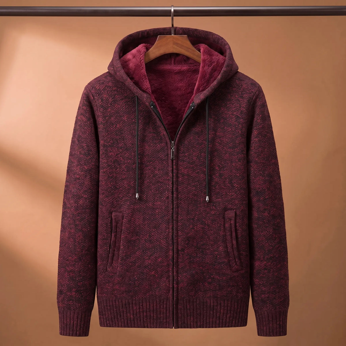 Marled knit hoodie in red with fleece-lined hood on a wooden hanger