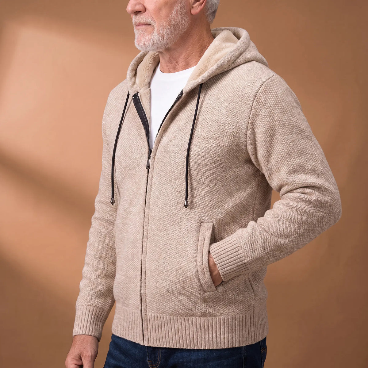 Side view of a man wearing the beige marled knit hoodie