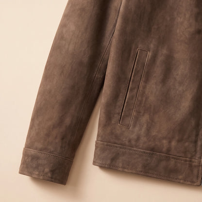 Close up of the cuff, hem and welt pocket on the matte finish jacket