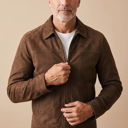 Man zipping up the brown matte finish jacket over a white tee