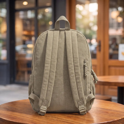 Neutral Corduroy Backpack back view - padded back panel, shoulder straps, top grab handle and back zip pocket