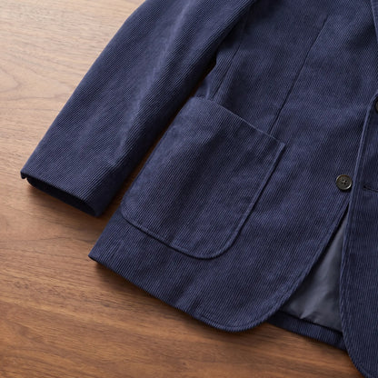 Close up of the patch pocket and button on the navy blue notch lapel blazer