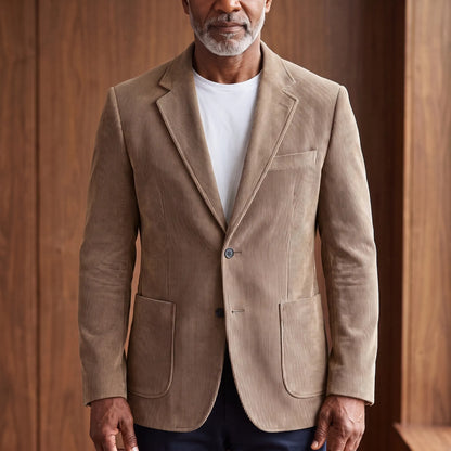 Men's khaki corduroy blazer with notch lapels and patch pockets, worn over a white T-shirt