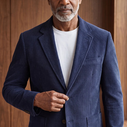 Man fastening the button on the navy blue notch lapel blazer