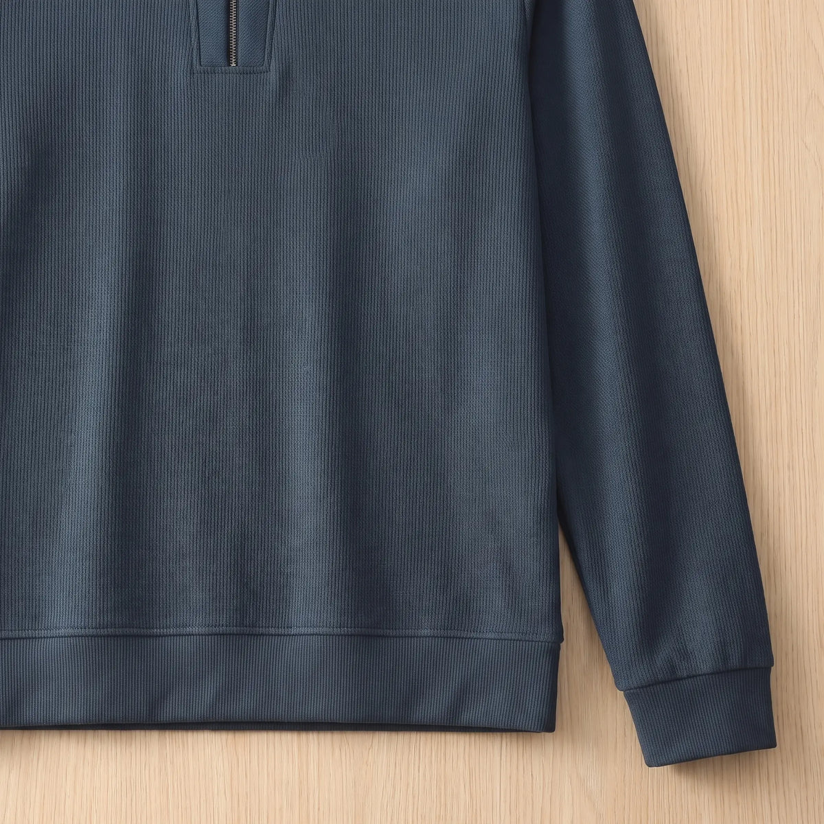 Close-up of the blue Notch Neck Pullover showing the textured knit, ribbed cuff and hem