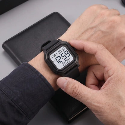 Man adjusting the black octagon digital watch on his wrist