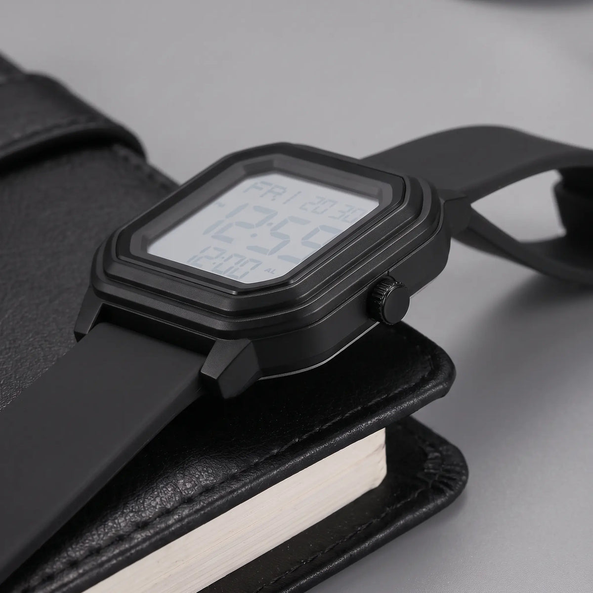 Side close-up of the black octagon digital watch showing the stepped bezel and side button